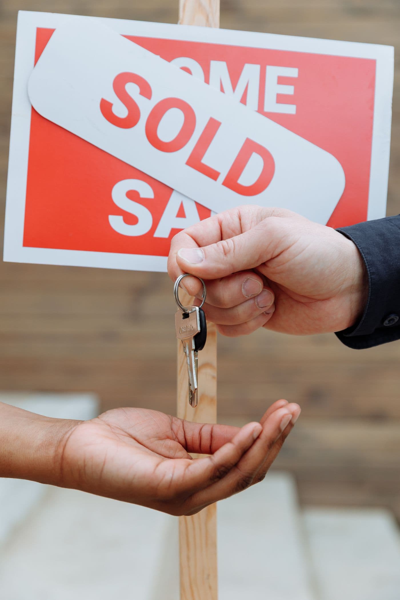 House keys being handed from one person to another